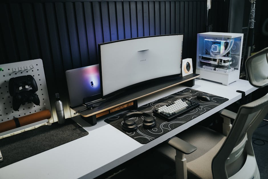 A sleek, modern office setup with a gaming PC, curved monitor, and accessories, ideal for tech enthusiasts.